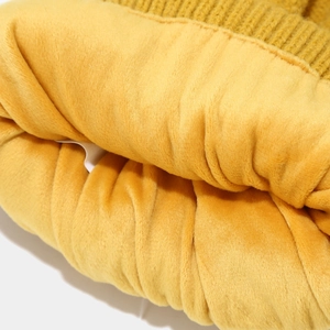 Close-up of the soft yellow knit fabric and thick fleece lining of the winter set