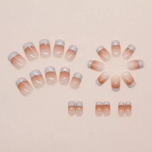 Detail of gradient cinnamon nails with glitter silver french tips and glossy finish
