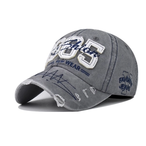 Detail of vintage washed grey cotton baseball cap with 85 embroidery and distressed brim