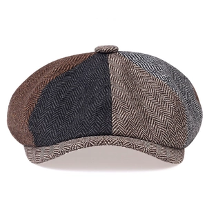 Detail of multi-color tweed patchwork newsboy cap with herringbone texture and octagonal top