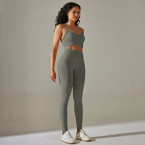 Detail view of seamless cross-back sports bra and high-waisted yoga leggings in sage green