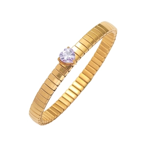 Detailed view of a gold stretch ring featuring a heart-shaped purple zircon stone setting