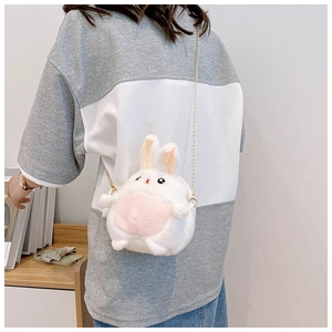 Back view of a white plush bunny crossbody bag with an elegant golden chain strap