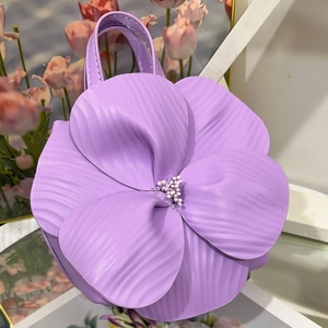 Detailed macro view of purple flower tote bag with layered petals and beaded stamen center