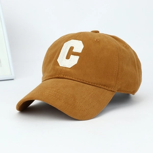 Detailed close-up of retro brown cotton baseball cap with white C patch embroidery