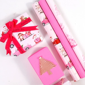 Pink cartoon Christmas gift wrapping paper rolls and gift boxes with festive ribbons