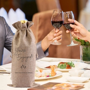 Linen wine gift bag with 'You're Engaged' print for celebration and wedding engagement