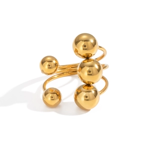 Macro view of gold spiral ring featuring polished spheres on a minimalist open band