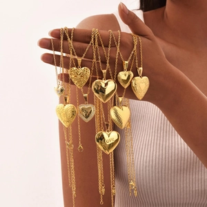 Golden heart-shaped stainless steel locket necklaces with engraved love patterns for women