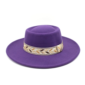 Detail of deep purple wool fedora with a bohemian ethnic pattern woven hat band