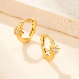 Detailed macro view of S925 sterling silver stamp on gold-plated star huggie earrings