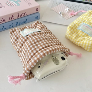 Detailed view of quilted checkered drawstring pouch for digital cameras and accessories