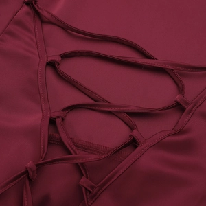 Detail of the cross-back lace-up design on the burgundy satin evening dress gown