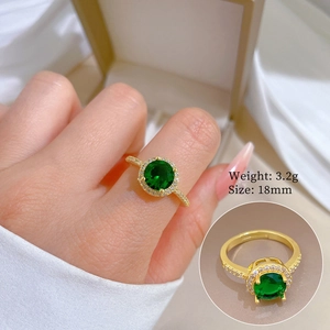 Detail of gold zircon ring with green gemstone showing 18mm size and 3.2g weight