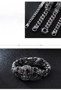 Macro detail of gothic stainless steel skull bracelet with red gemstone eyes and cross