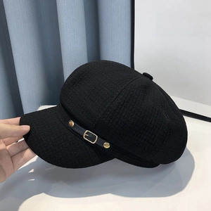 Classic black newsboy cap in tweed fabric with leather strap and gold buckle detail