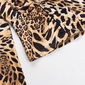 Macro shot of leopard print top showing detailed stitching and pleated hem craftsmanship