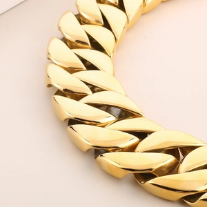 Macro shot of high-polished golden Cuban link chain dog collar showing tight links