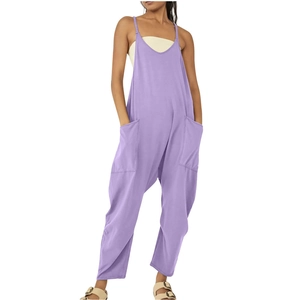 Detail of purple loose fit jumpsuit featuring deep V-neck, thin straps and large side pockets