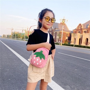 Detail of cute pink strawberry crossbody bag with adjustable strap for little girls