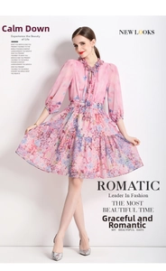 Close-up of pink chiffon floral dress featuring ruffled neckline and delicate bow tie