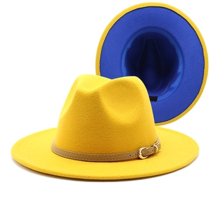 Detail of yellow wool fedora featuring royal blue lining and a brown leather belt buckle