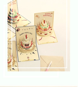 Detail of 3D pop-up birthday card with colorful layered cake design and envelope