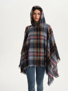 Detail of multi-colored checkered hooded poncho featuring soft knit fringe edges