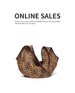 Detail of leopard print tote bag with brown leather trim and retro branding label