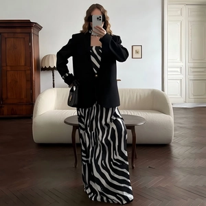 Chic black long-sleeved blazer jacket paired with zebra print skirt for a stylish look