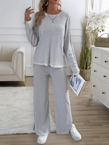 Gray knitted two-piece lounge set with white trim details and wide-leg pants