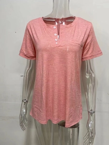 Detail view of pink V-neck T-shirt with button placket and functional front pocket