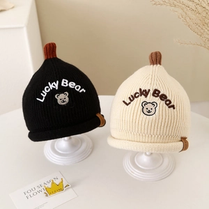 Winter knitted baby beanies with Lucky Bear embroidery in black and cream white colors