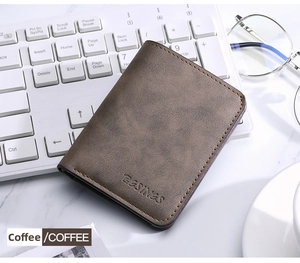 Detail of coffee brown leather card holder featuring vintage texture and yellow stitching