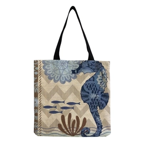 Foldable canvas tote bag with seahorse and coral print featuring black handles