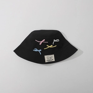 Black cotton bucket hat for girls with colorful bow ties and minimalist woven label