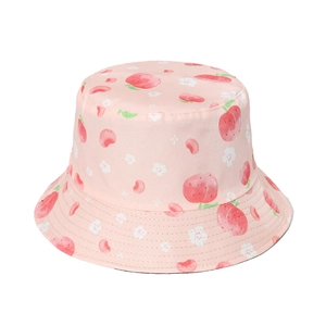 Pink cotton bucket hat with red strawberry pattern for women in a studio view