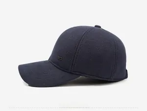 Side view of navy blue winter baseball cap with thick knitted texture and metal detail