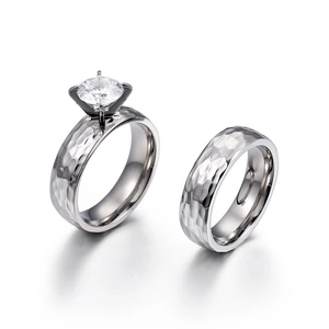 Minimalist silver hammered stainless steel couple rings with a sparkling solitaire diamond