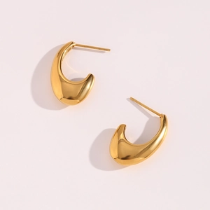 Detailed view of gold minimalist C-shaped streamline earrings with a mirror-polished finish