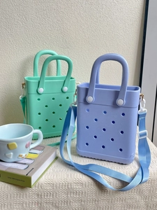 Detail of mint green and purple EVA beach bags with adjustable wide shoulder straps