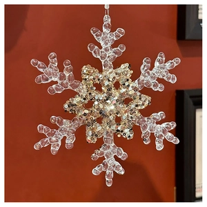 Close-up of snowflake ornament with acrylic texture and champagne gold sequins