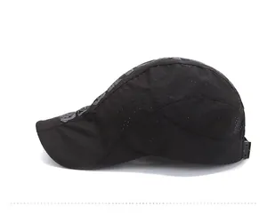 Close-up of black breathable polyester mesh cap with laser-cut holes and adjustable strap