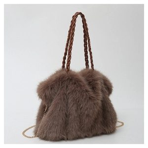 Detail of dark brown faux fur tote bag showing plush texture and woven leather handles
