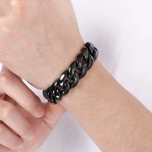 Close-up of black 18mm Cuban link stainless steel bracelet worn on a male wrist