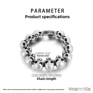 Close-up of vintage stainless steel skull link bracelet with cross relief clasp details
