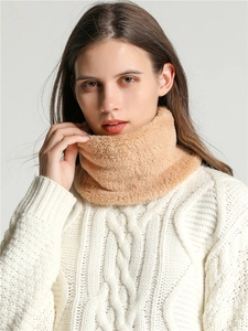 Close-up of camel plush neck warmer on model showing soft coral fleece texture
