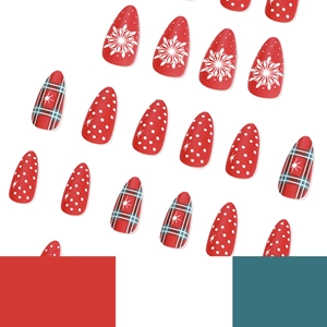 Christmas press-on nails with red snowflakes, white polka dots and green plaid patterns
