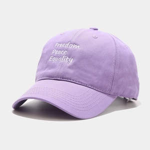 Close-up of lavender baseball cap showing Freedom Peace Equality white embroidery