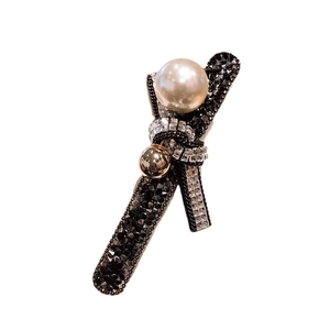 Elegant black ribbon bow hair clip featuring sparkling rhinestones and white pearls